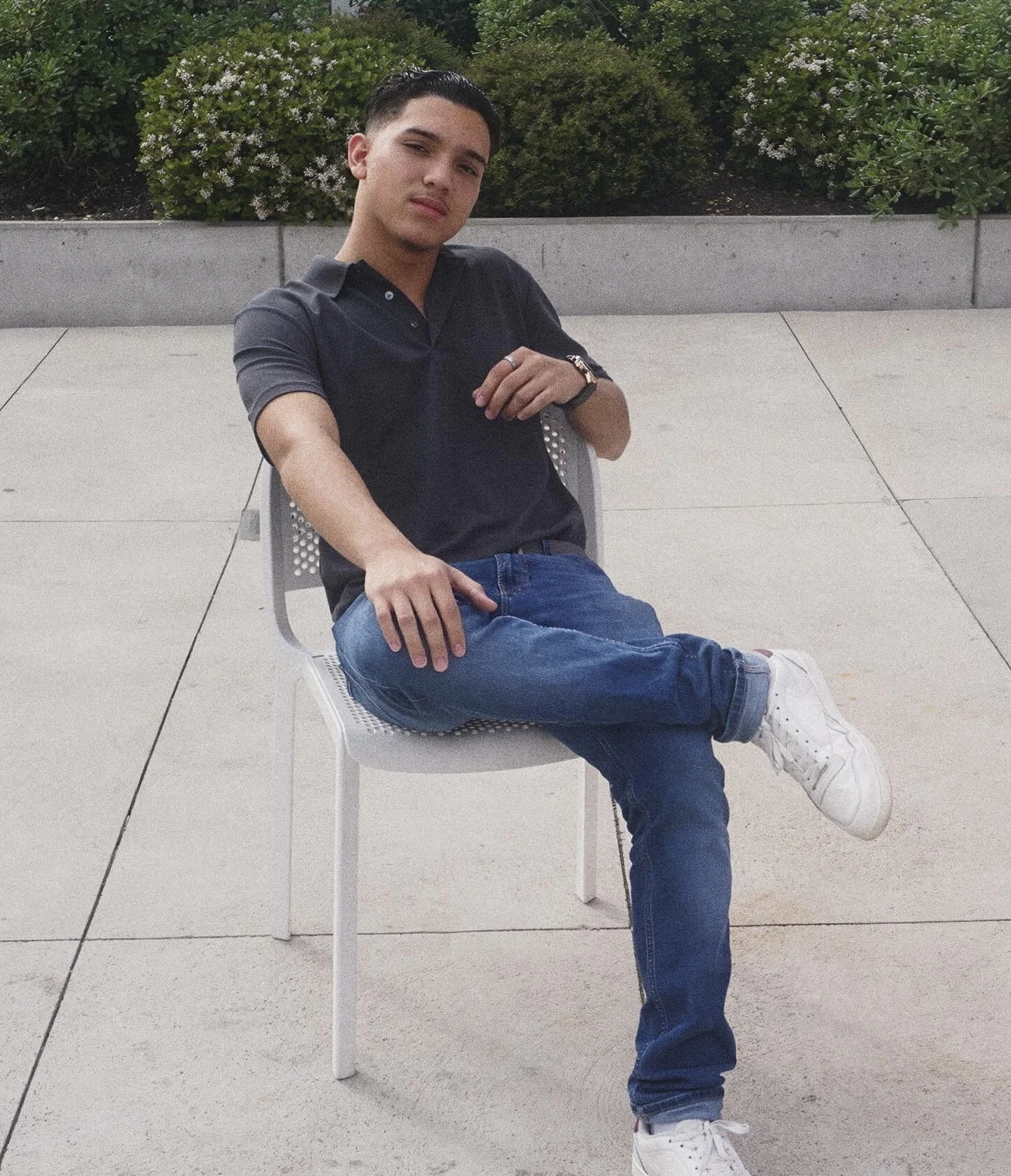 Portrait of Kenny Perez Calix seated outdoors